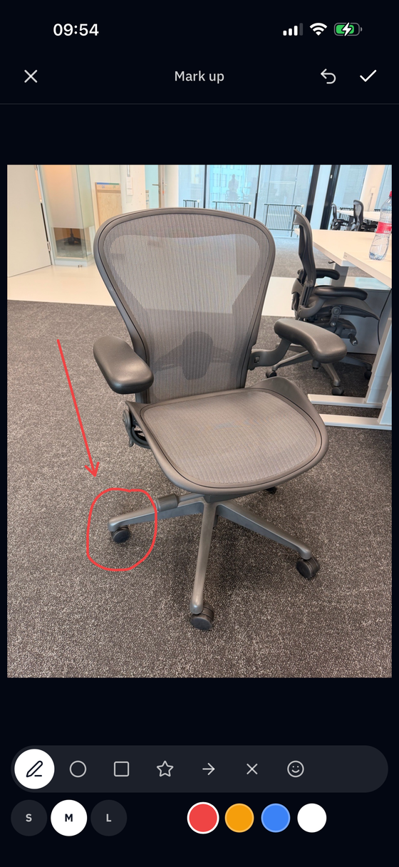 Marking up the same photo in Beam — a worn castor circled and arrowed in red